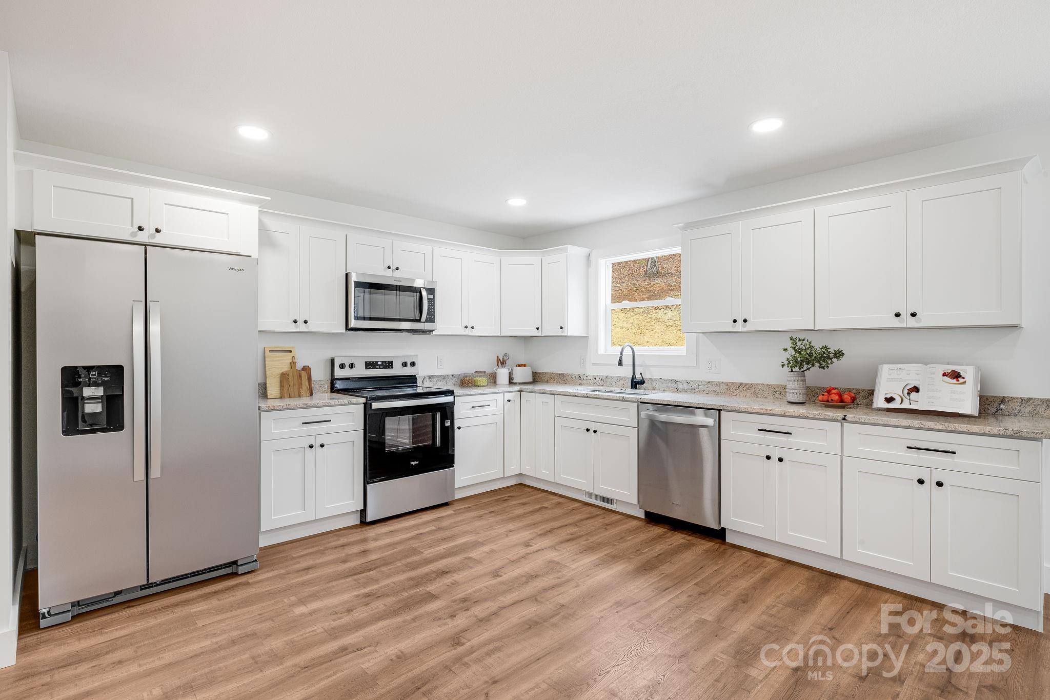382 Holtzclaw Street Canton, NC 28716 - Photo 14 of 34 a kitchen with granite countertop white cabinets and stainless steel appliances