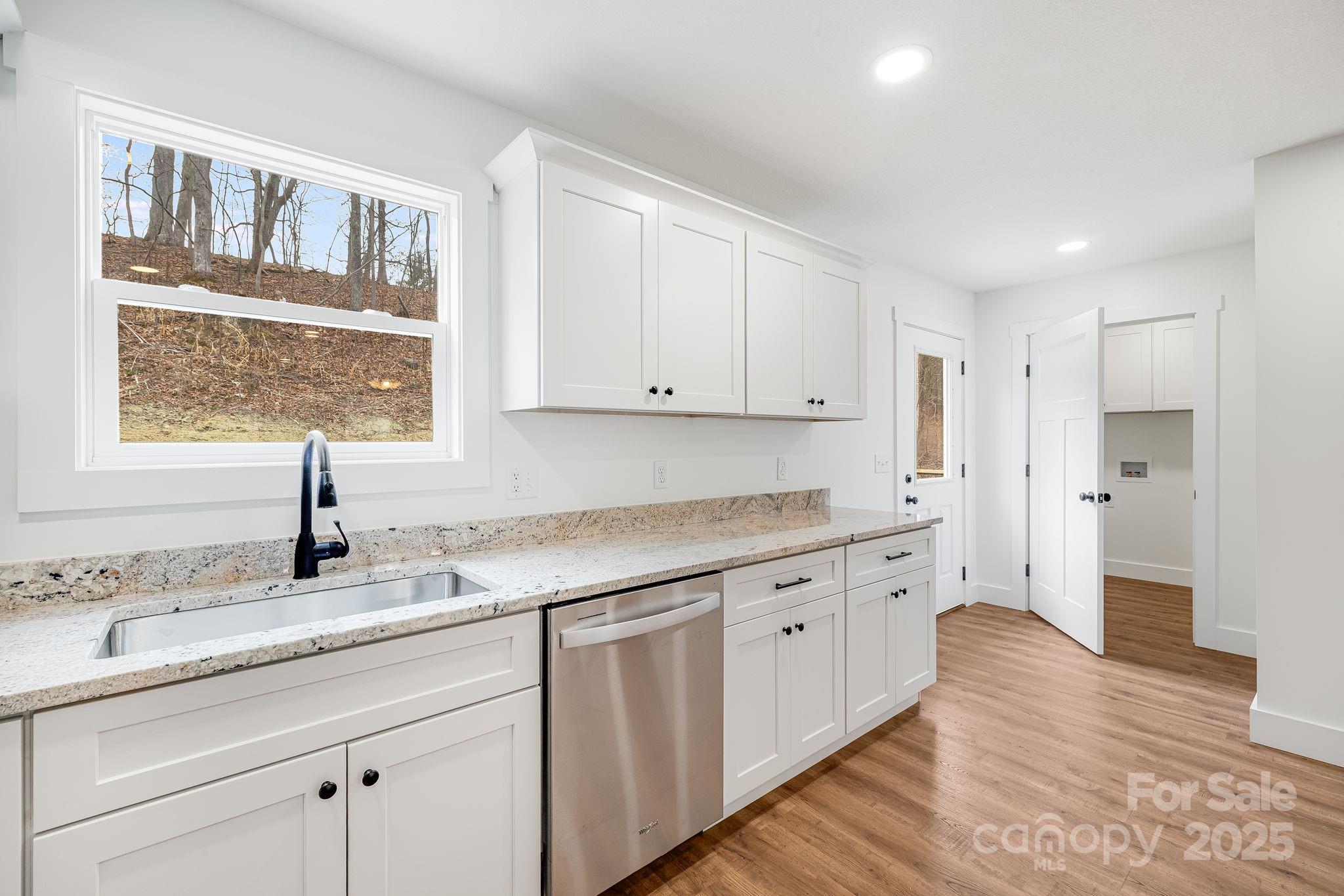 382 Holtzclaw Street Canton, NC 28716 - Photo 17 of 34 a kitchen with granite countertop white cabinets and white appliances