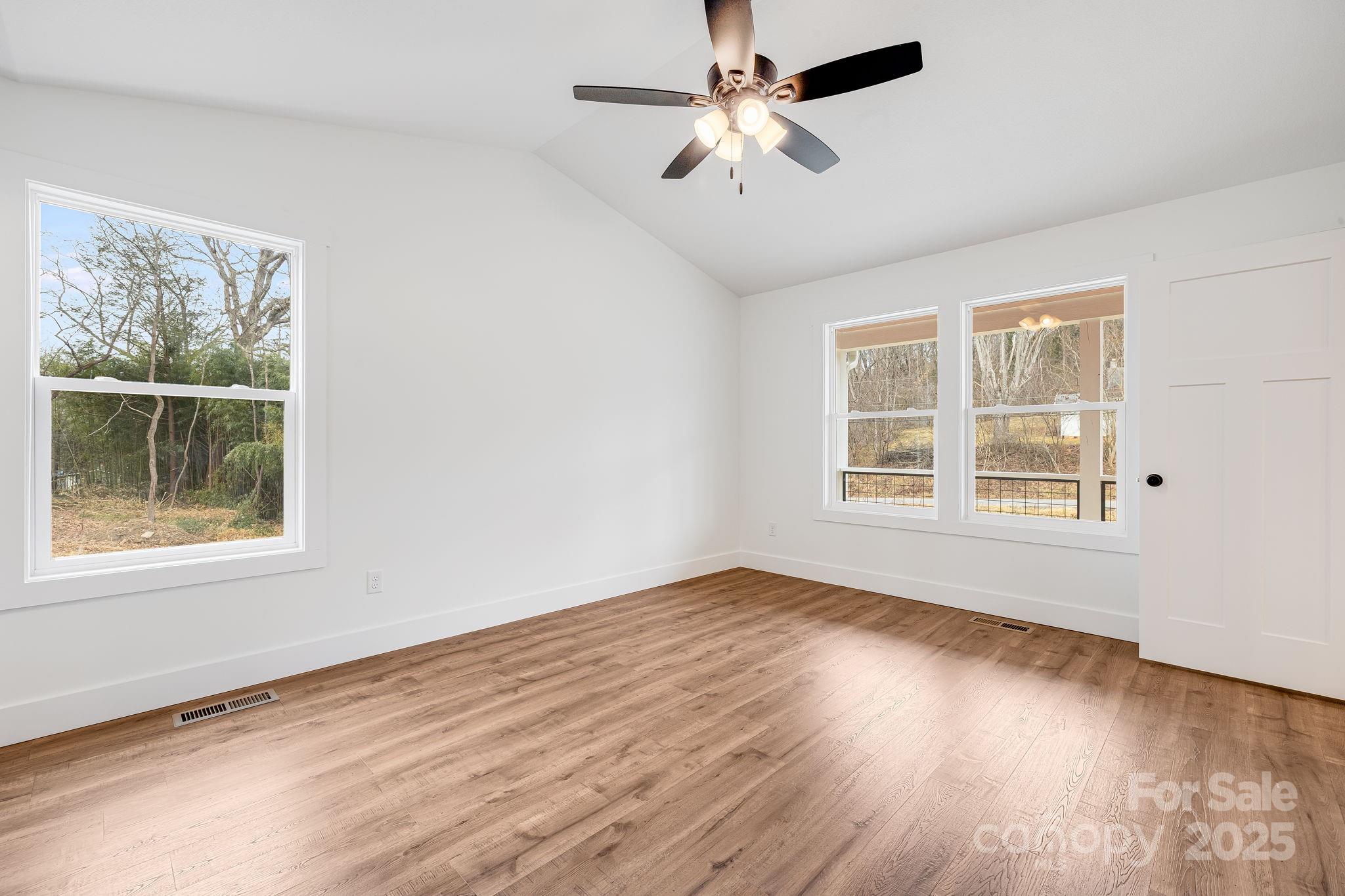 382 Holtzclaw Street Canton, NC 28716 - Photo 21 of 34 a view of an empty room with wooden floor and a window