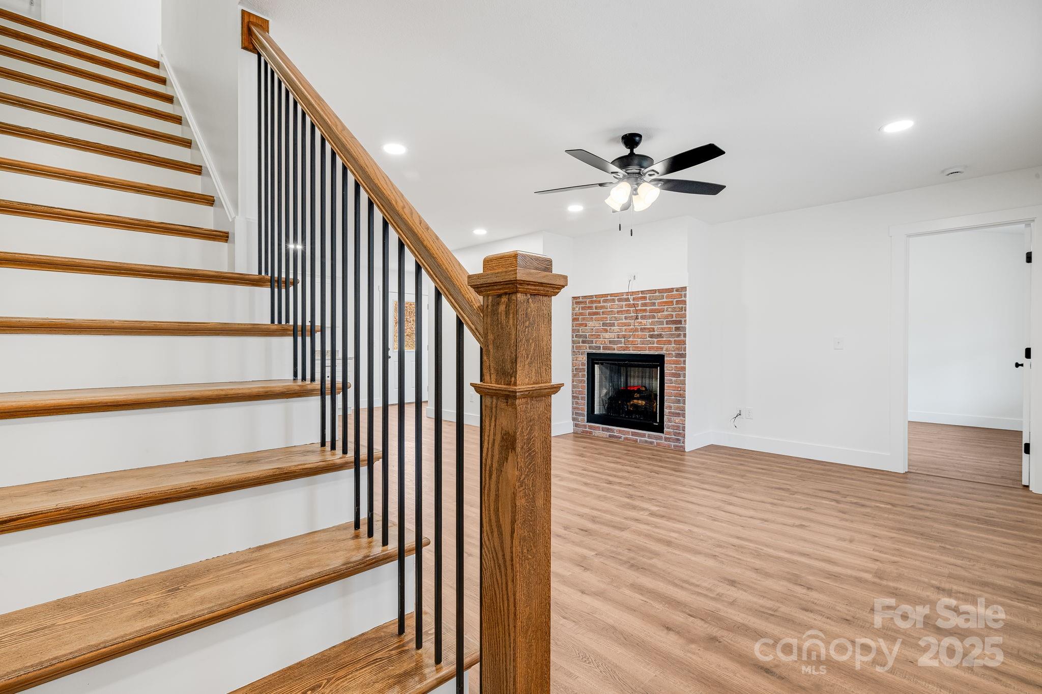 382 Holtzclaw Street Canton, NC 28716 - Photo 25 of 34 a view of a livingroom with a ceiling fan and a fireplace