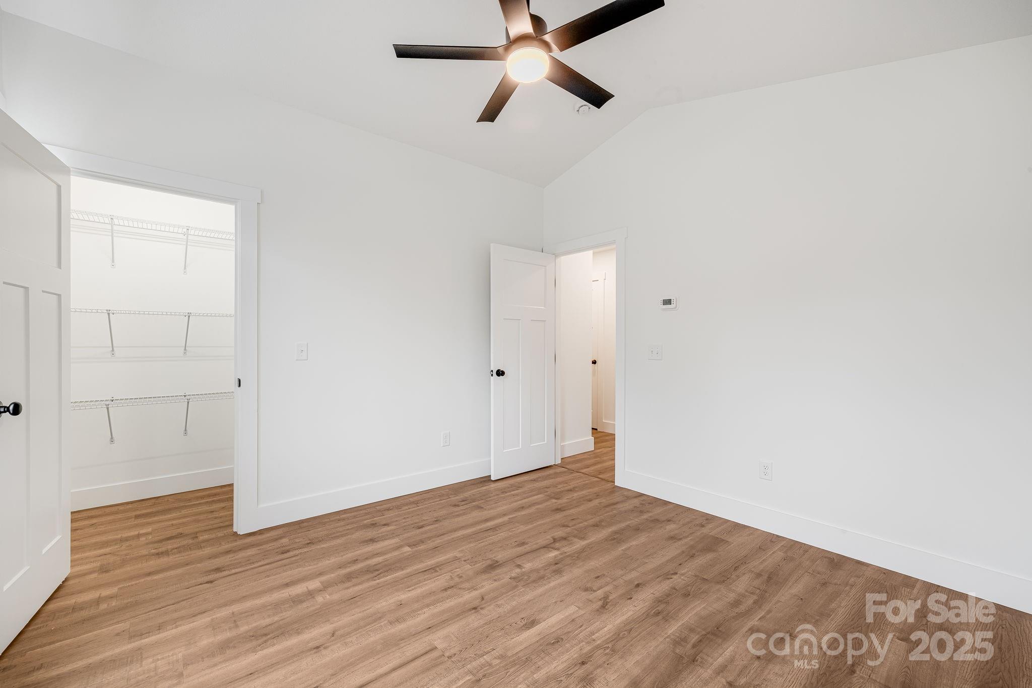 382 Holtzclaw Street Canton, NC 28716 - Photo 28 of 34 a view of a room with wooden floor and ceiling fan