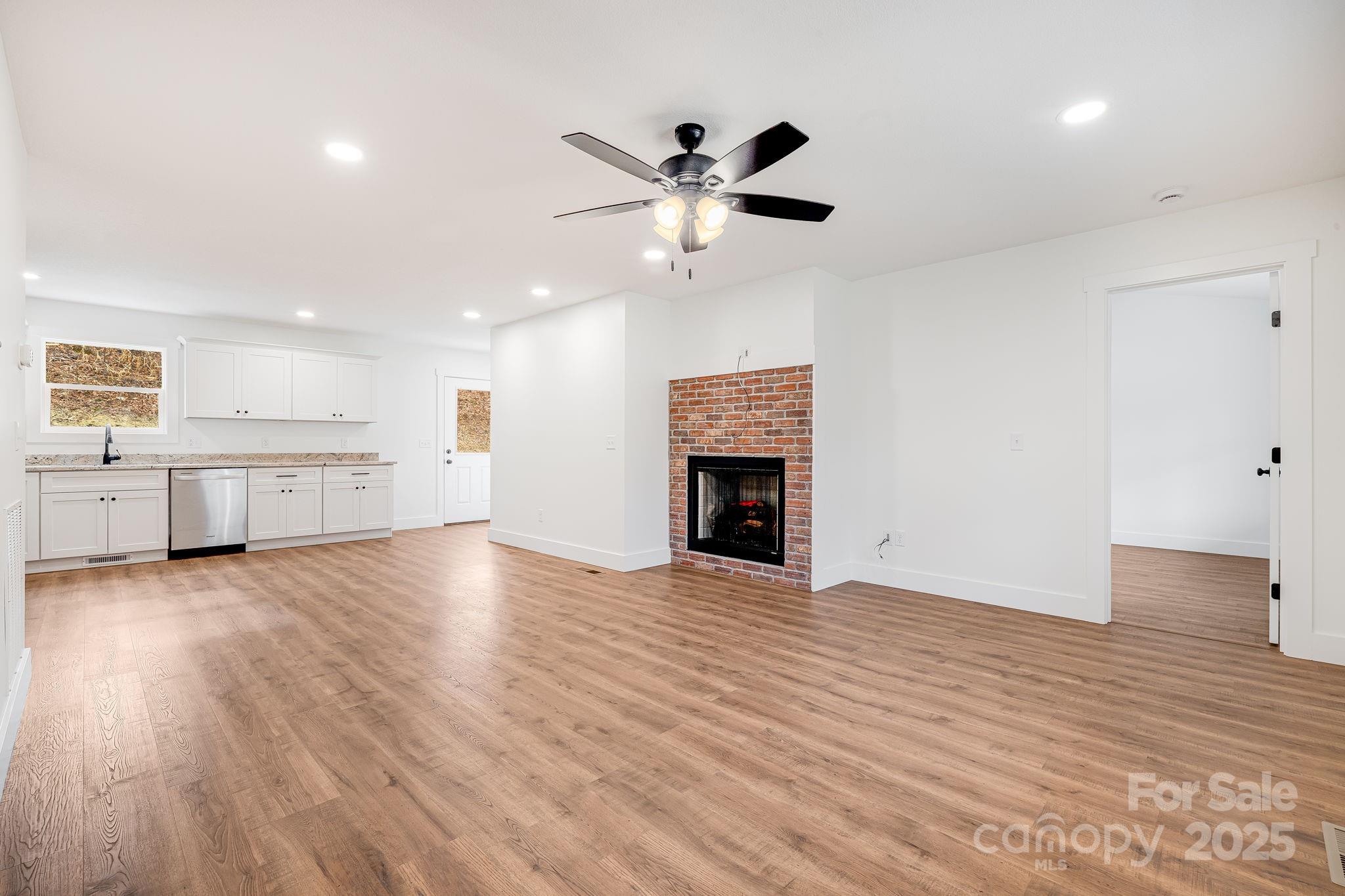 382 Holtzclaw Street Canton, NC 28716 - Photo 9 of 34 a view of an empty room with window and wooden floor