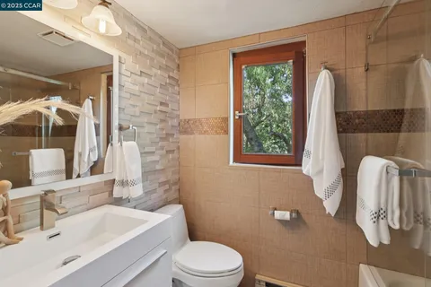 a living room with furniture and stairs