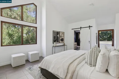 a bedroom with a bed and a potted plant
