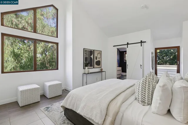 a bedroom with a bed and a potted plant