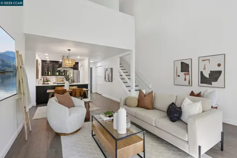 a dining room with a table chairs and a kitchen view