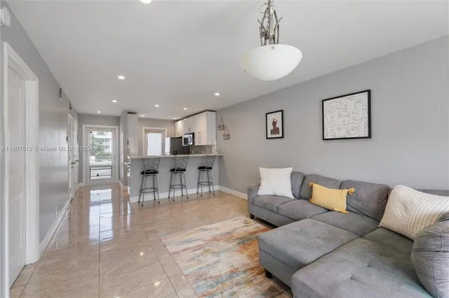 a bedroom with a bed a chandelier and a window