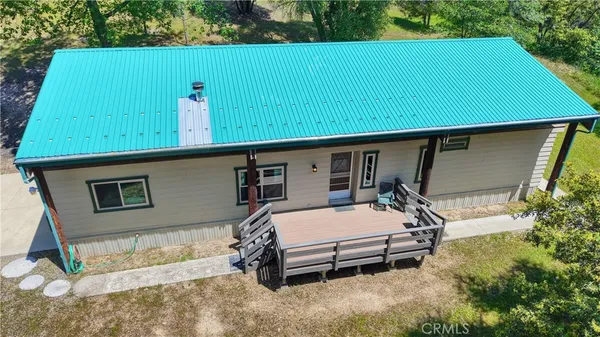 a backyard of a house with barbeque oven table and chairs