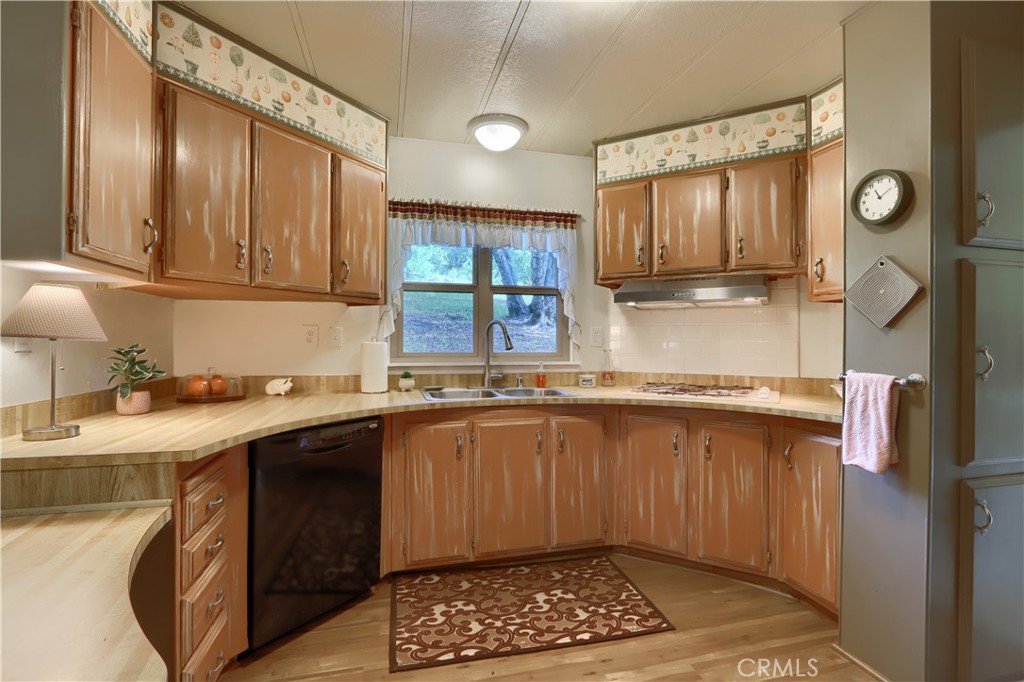 2843 East Westfall Road Mariposa, CA 95338 - Photo 12 of 47 a kitchen with a sink window and cabinets
