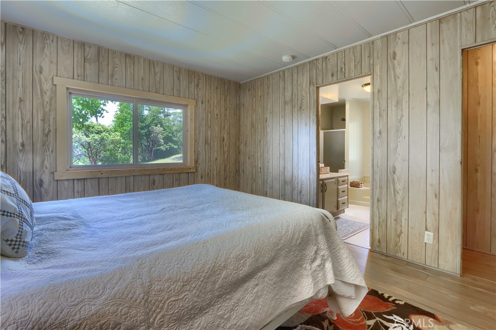 2843 East Westfall Road Mariposa, CA 95338 - Photo 19 of 47 a bedroom with a bed and a dresser next to a window