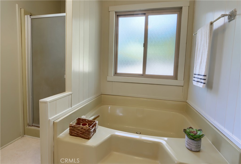 2843 East Westfall Road Mariposa, CA 95338 - Photo 21 of 47 a bath tub sitting in a bathroom next to a window
