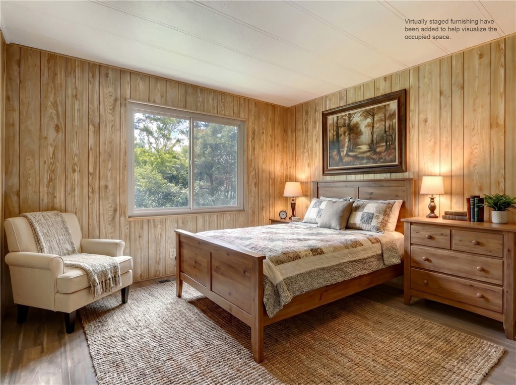 2843 East Westfall Road Mariposa, CA 95338 - Photo 25 of 47 a bedroom with a bed and a couch with wooden floor