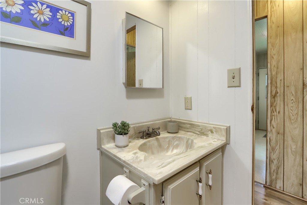 2843 East Westfall Road Mariposa, CA 95338 - Photo 27 of 47 a bathroom with a granite countertop sink and a mirror