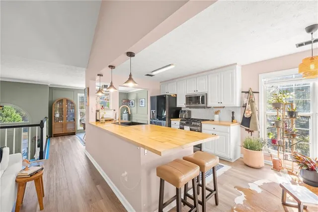 a large kitchen with a table and chairs in it