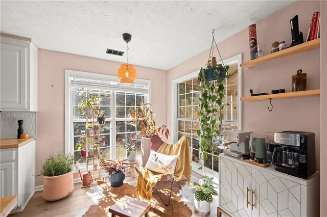 a very nice looking living room with a potted plant