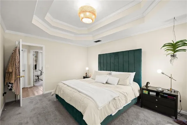 a bedroom with a bed and a chandelier