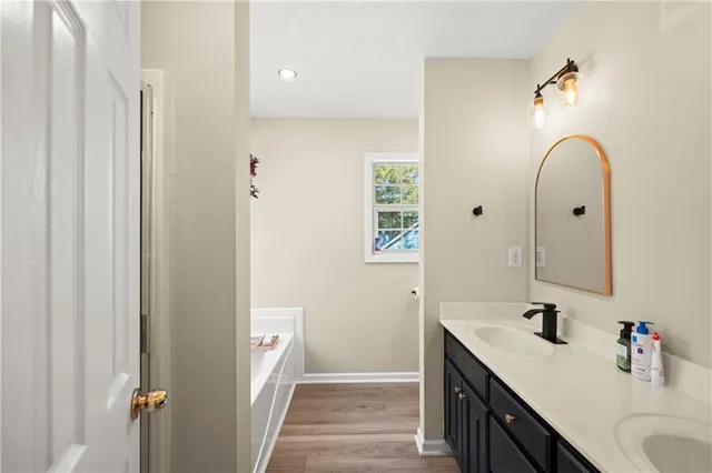 a bathroom with a double vanity sink and a mirror