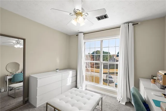a spacious bathroom with a toilet sink and a mirror