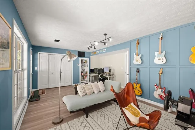 a view of a room with wooden floor and furniture