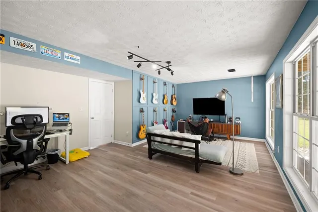 a view of a workspace with furniture and a window