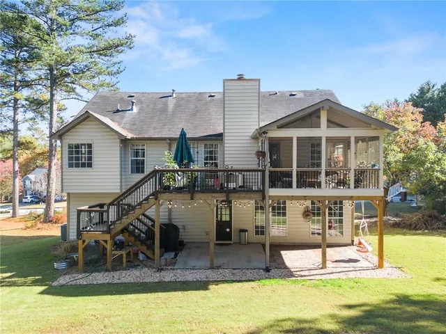 a view of a house with a big yard and palm trees