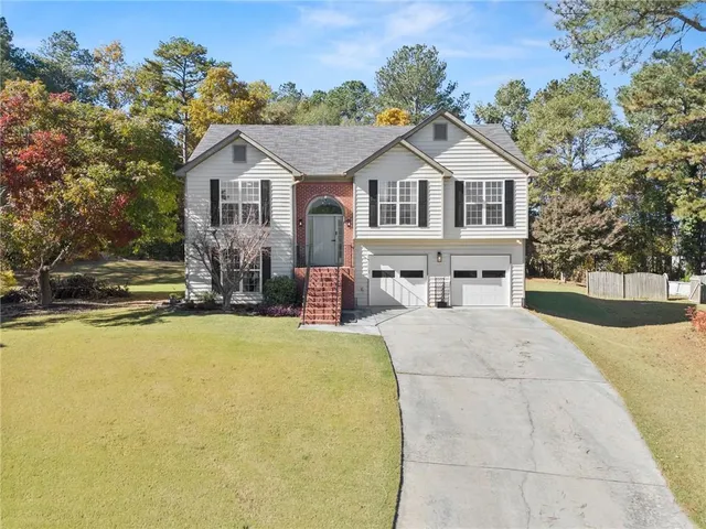 a view of house with outdoor space and sitting area