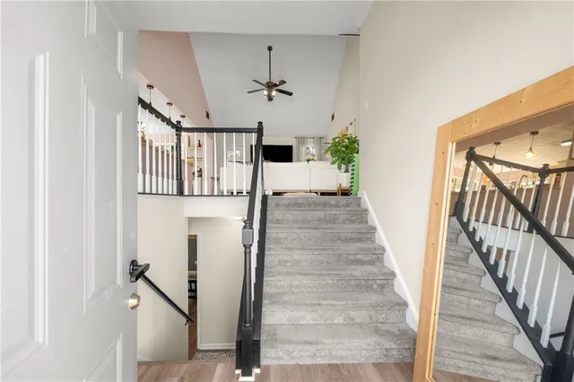 a view of a hallway with wooden floor and staircase
