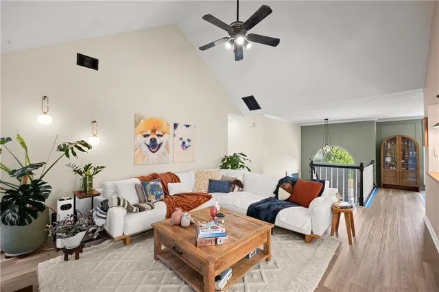 a living room with furniture and wooden floor