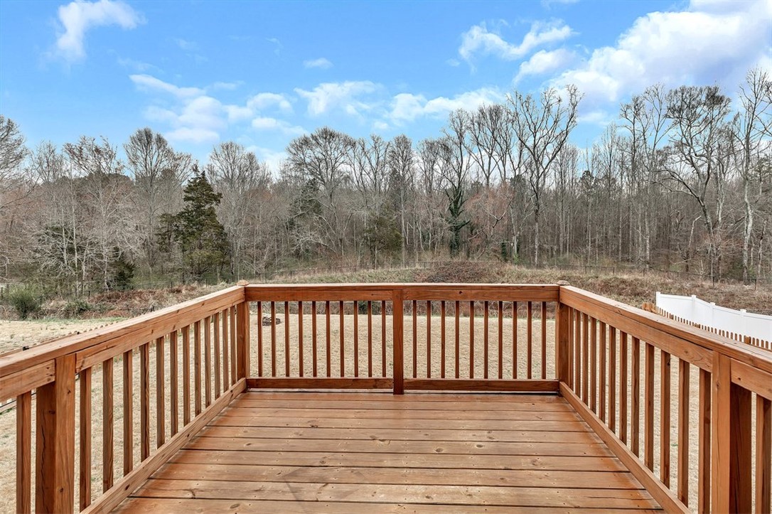 150 Queens Mill Court Pendleton, SC 29670 - Photo 32 of 37 This spacious wooden deck offers expansive views of a serene, tree-lined landscape.