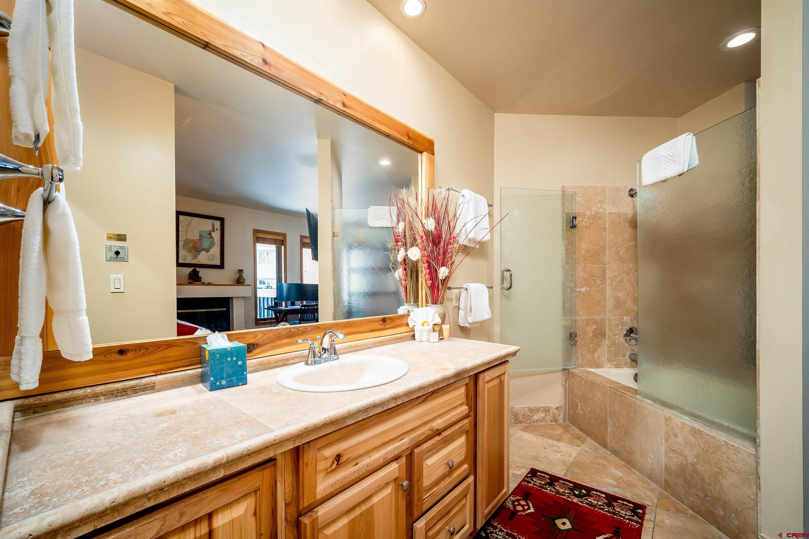 71 East Needles Road, Unit 337 Durango, CO 81301 - Photo 14 of 45 a bathroom with a sink a large mirror and shower