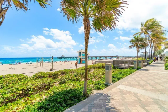 a view of a street with a beach