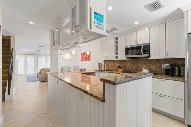 a kitchen with stainless steel appliances granite countertop a sink and a stove