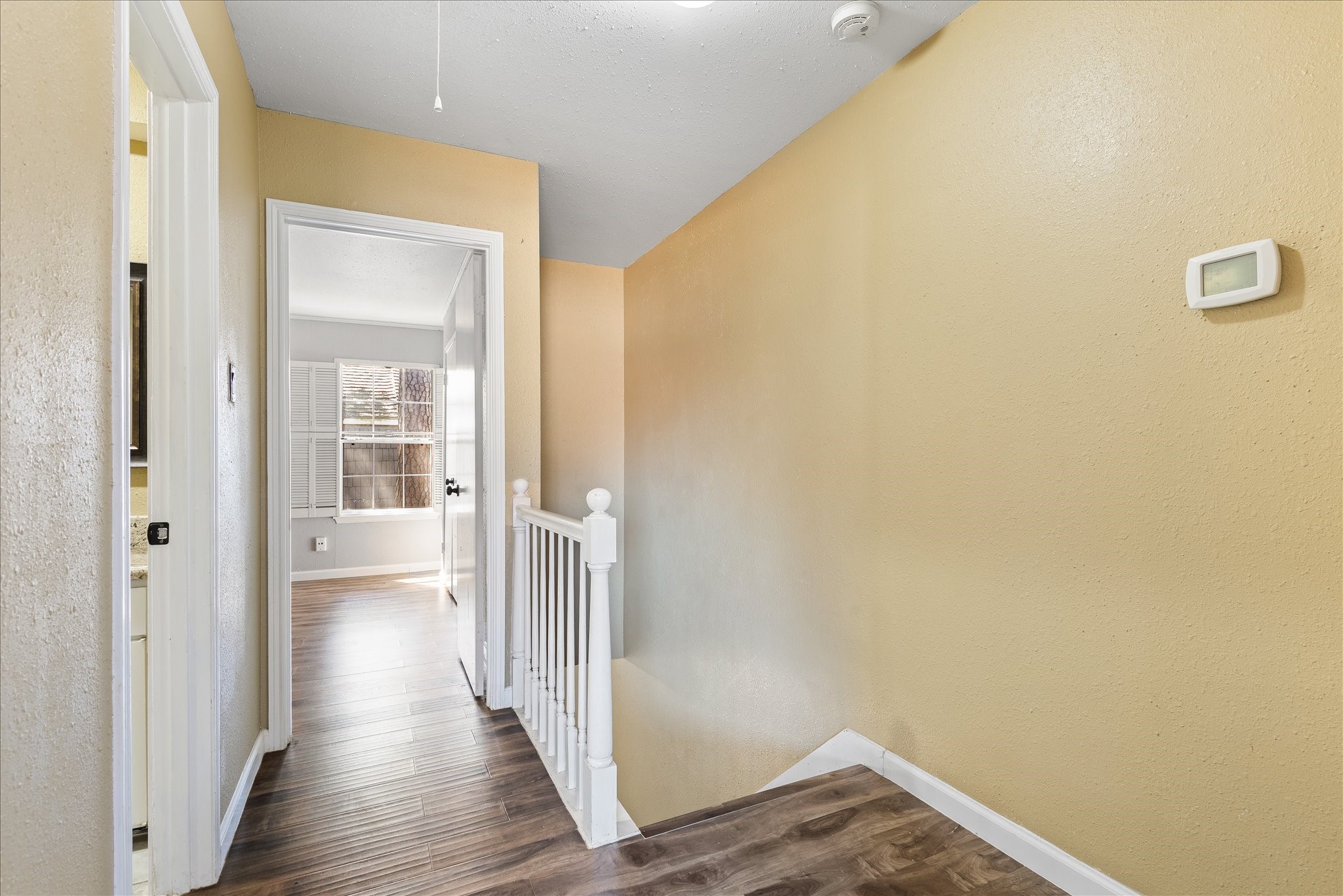 1425 Springrock Lane Houston, TX 77055 - Photo 13 of 30 a view of a hallway with wooden floor