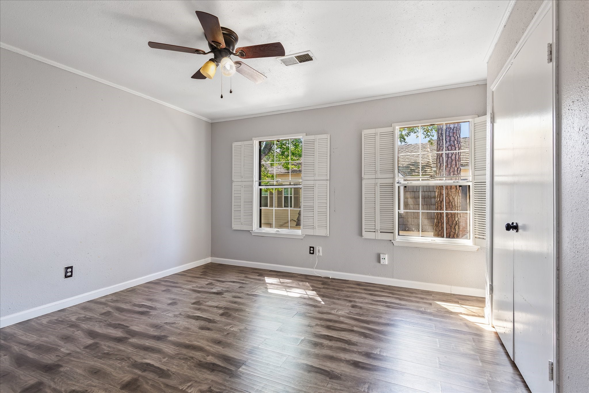 1425 Springrock Lane Houston, TX 77055 - Photo 14 of 30 a view of an empty room with a window and wooden floor
