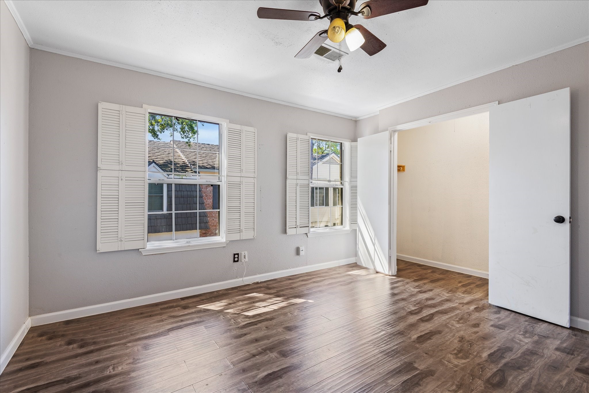 1425 Springrock Lane Houston, TX 77055 - Photo 15 of 30 a view of an empty room with a window and wooden floor