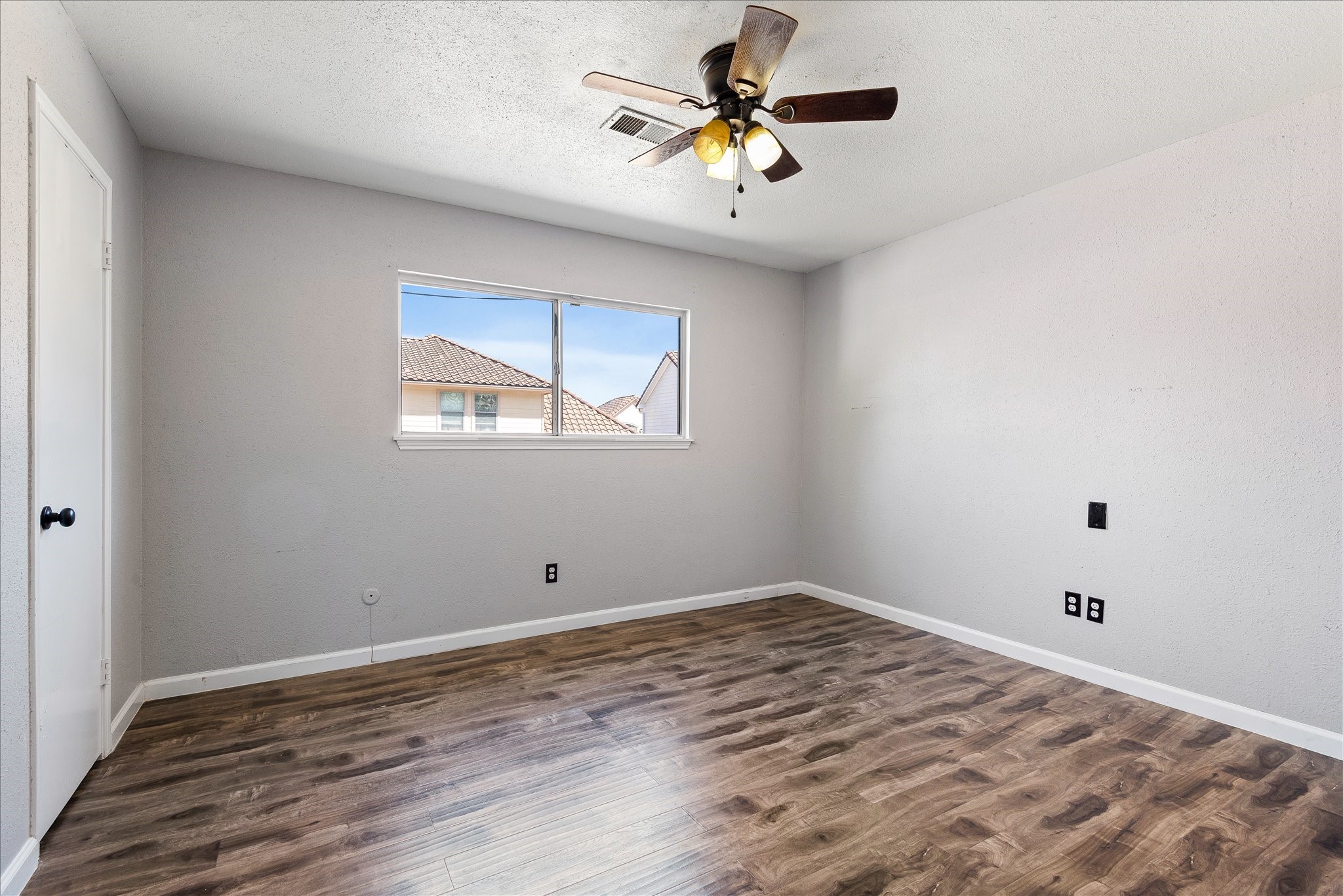 1425 Springrock Lane Houston, TX 77055 - Photo 16 of 30 an empty room with a window and a fan