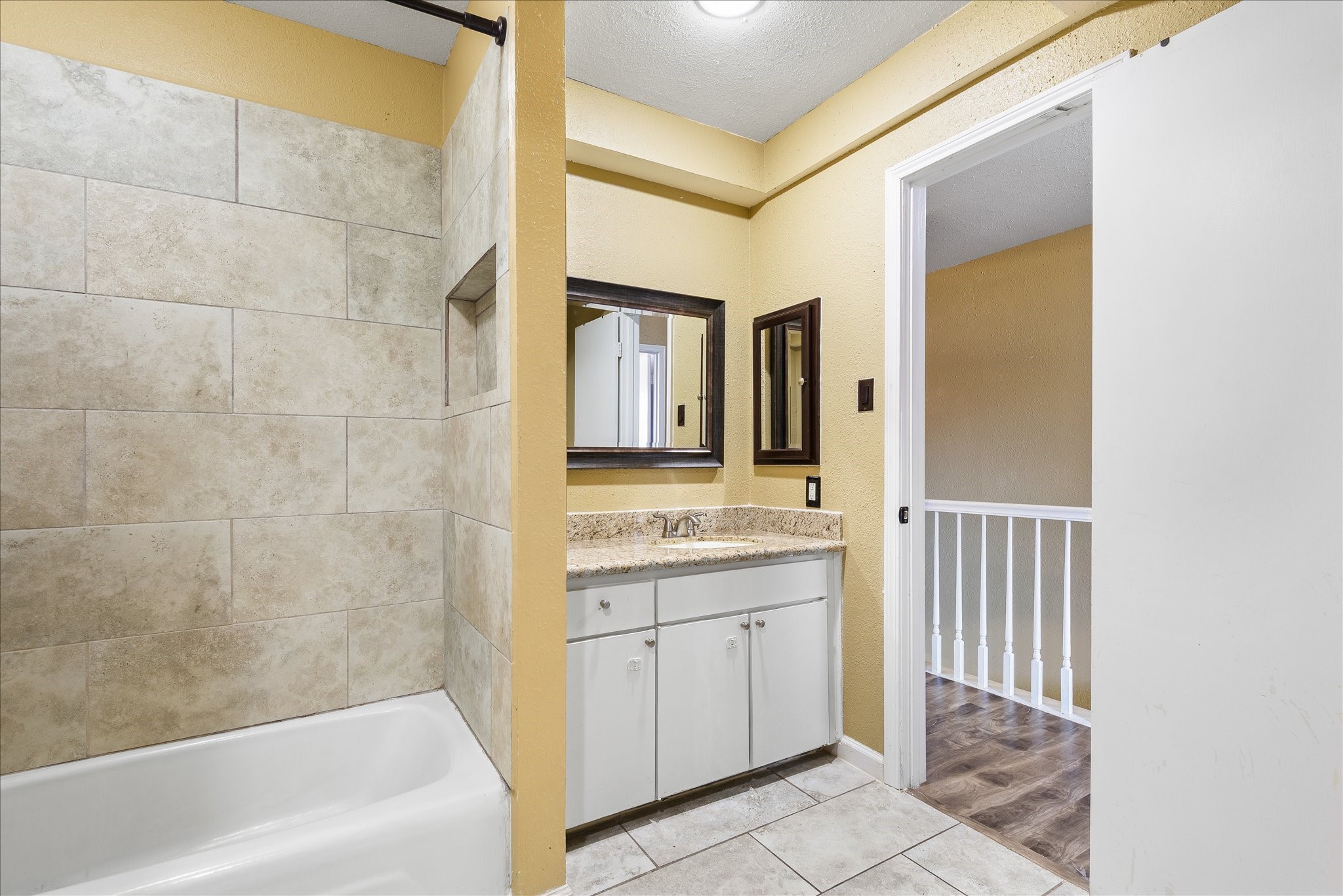 1425 Springrock Lane Houston, TX 77055 - Photo 19 of 30 a bathroom with a granite countertop sink a toilet and bathtub