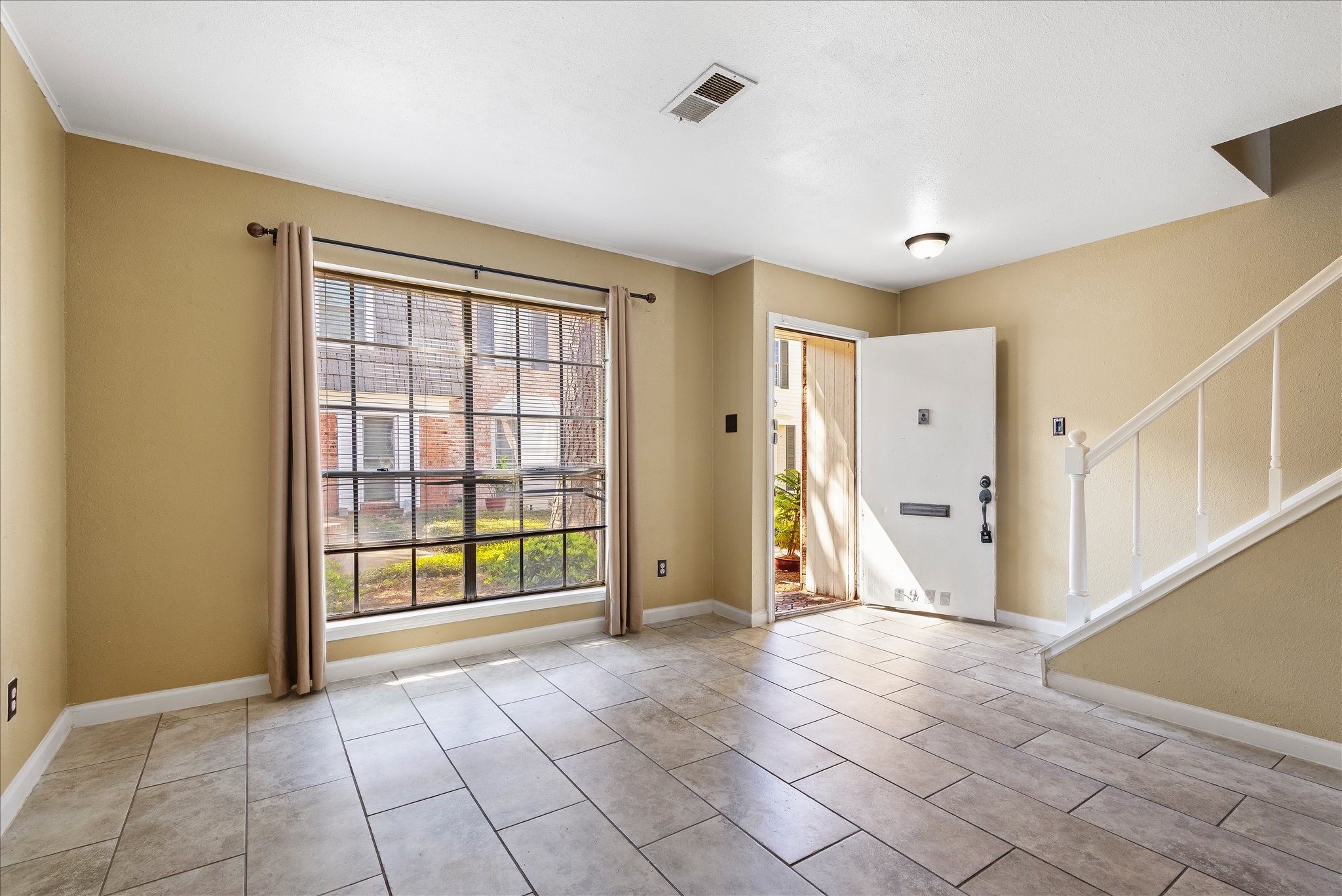 1425 Springrock Lane Houston, TX 77055 - Photo 4 of 30 a view of an empty room with glass door