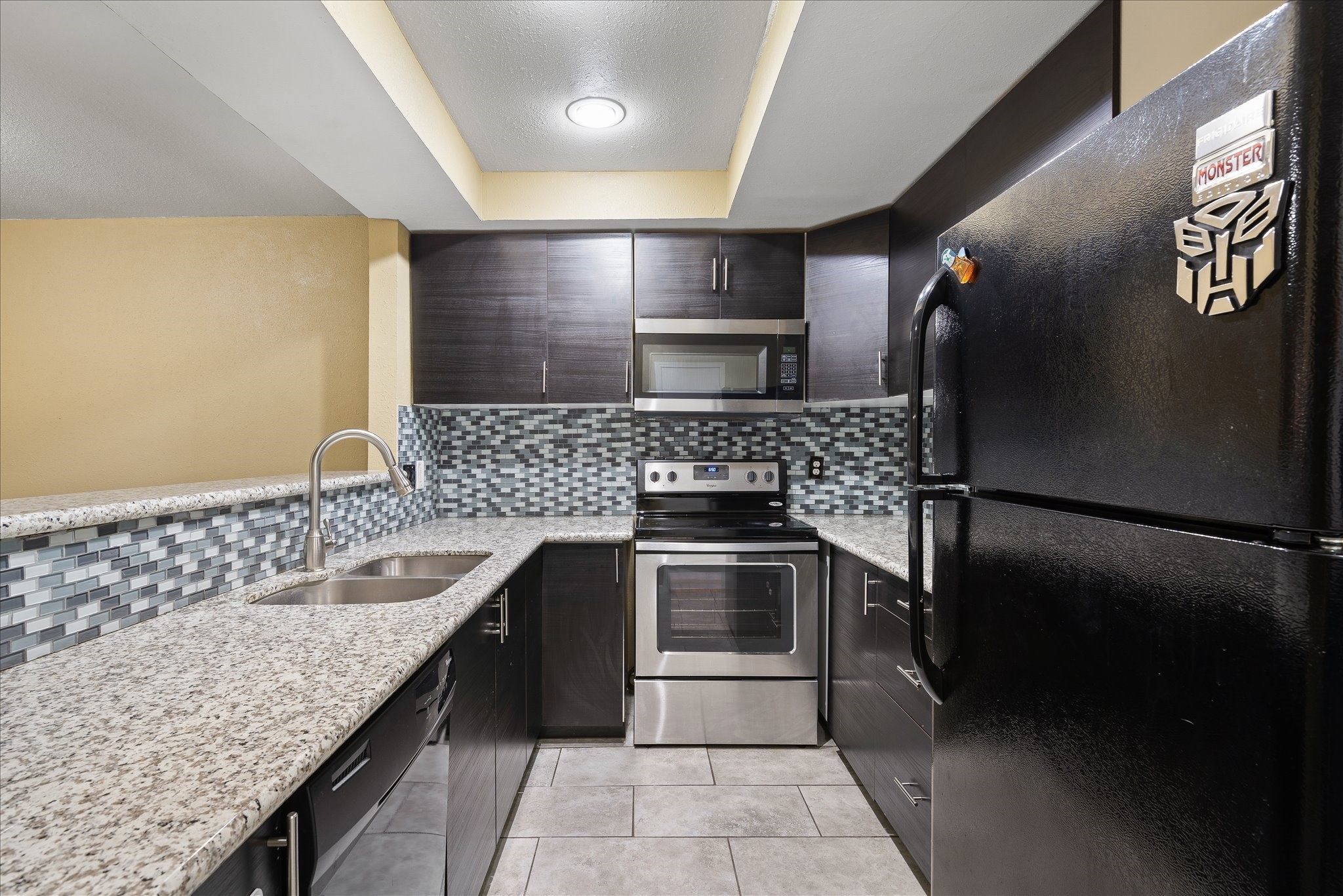 1425 Springrock Lane Houston, TX 77055 - Photo 7 of 30 a kitchen with stainless steel appliances granite countertop a sink stove and refrigerator