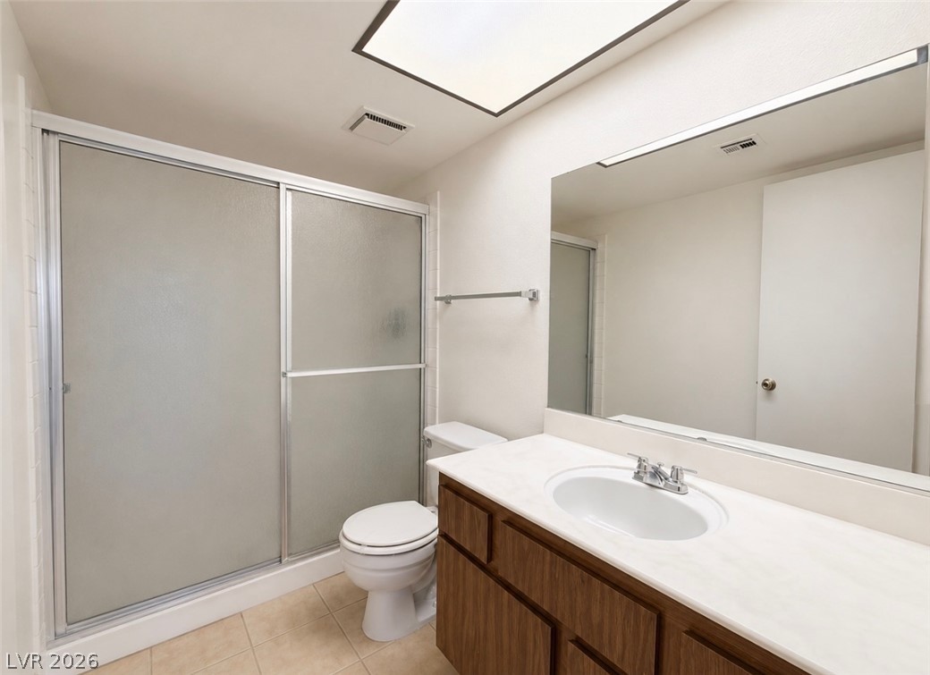 6491 West Viking Road Las Vegas, NV 89103 - Photo 3 of 5 A well-appointed bathroom with a spacious shower and a vanity with ample counter space.