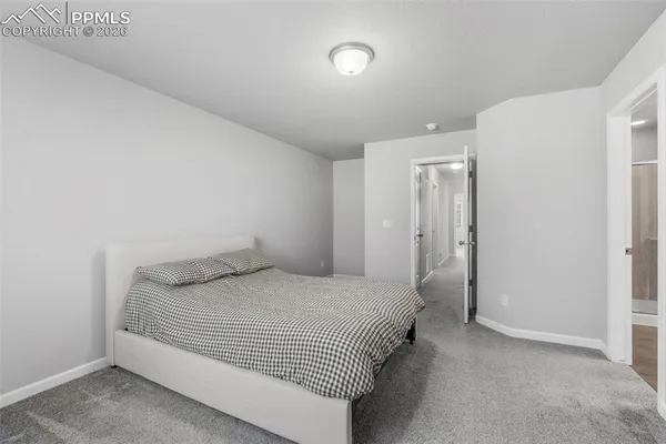 a bedroom with a bed and a night stand