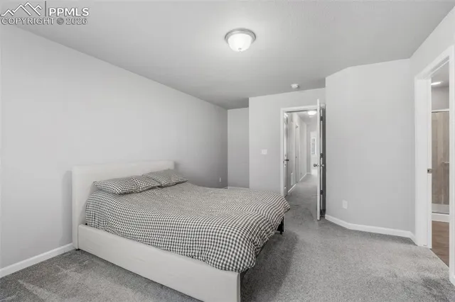 a bedroom with a bed and a night stand