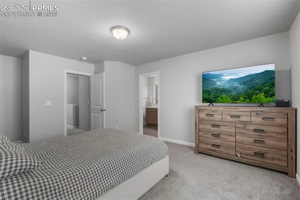 a bedroom with a bed and a dresser
