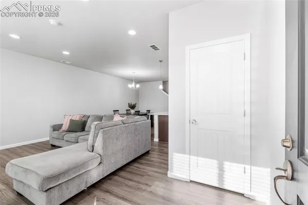 a living room with furniture and a glass door