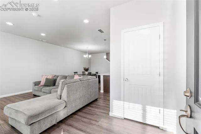a living room with furniture and a glass door