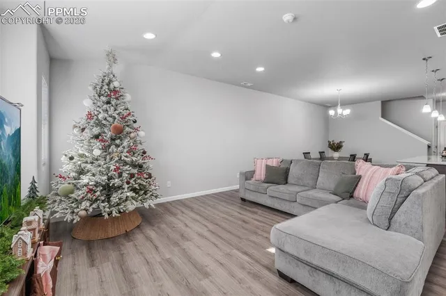a living room with furniture and a christmas tree