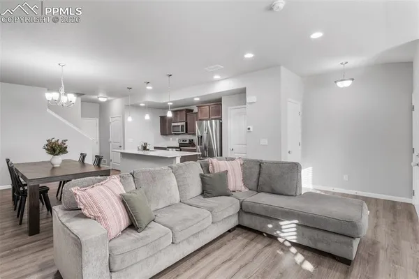 a living room with furniture and kitchen view