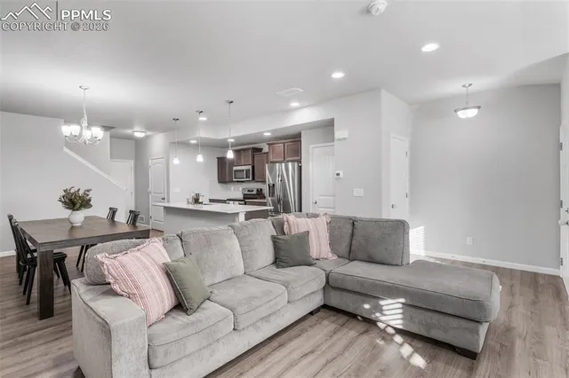 a living room with furniture and kitchen view