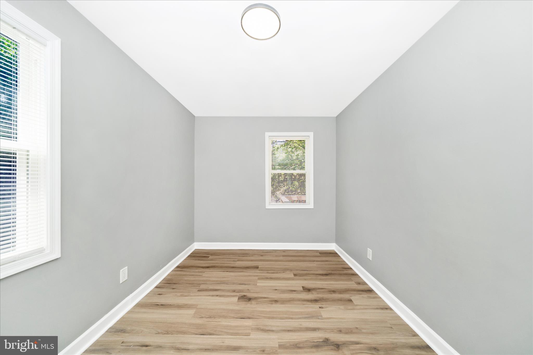 5027 Benning Road Southeast Washington, DC 20019 - Photo 41 of 57 an empty room with wooden floor and windows