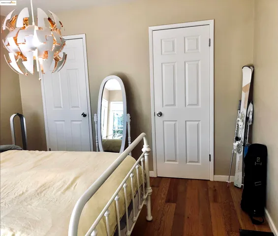 a bedroom with a bed and a flat tv screen on the dresser